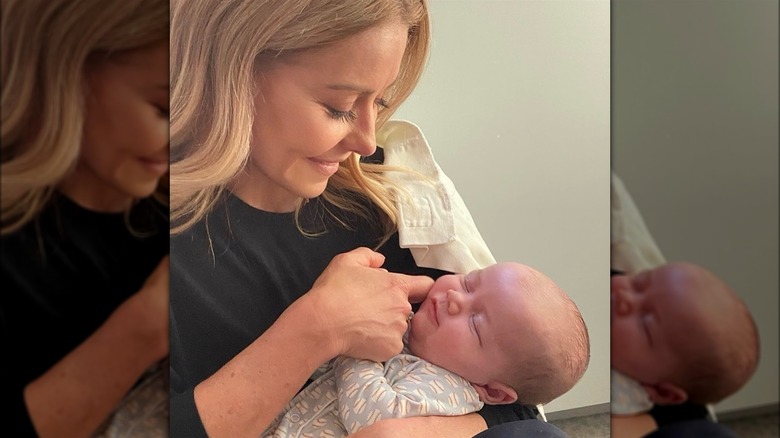 Kelly Ripa holding Anderson Cooper's son