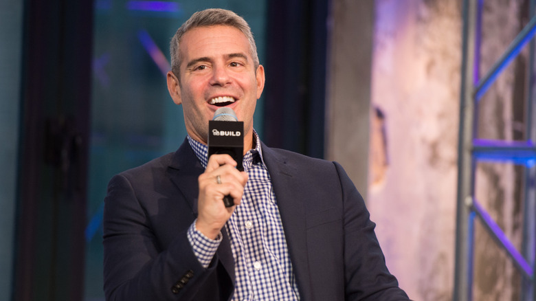 Andy Cohen talking into a microphone