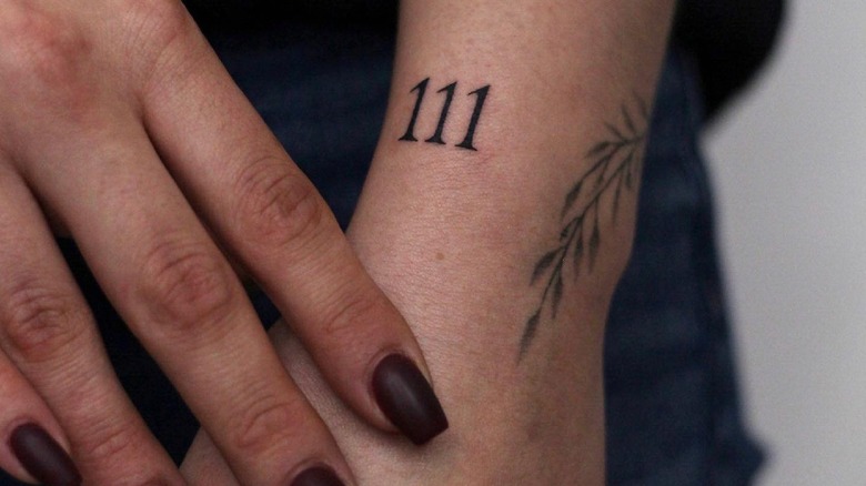 111 tattooed near the wrist