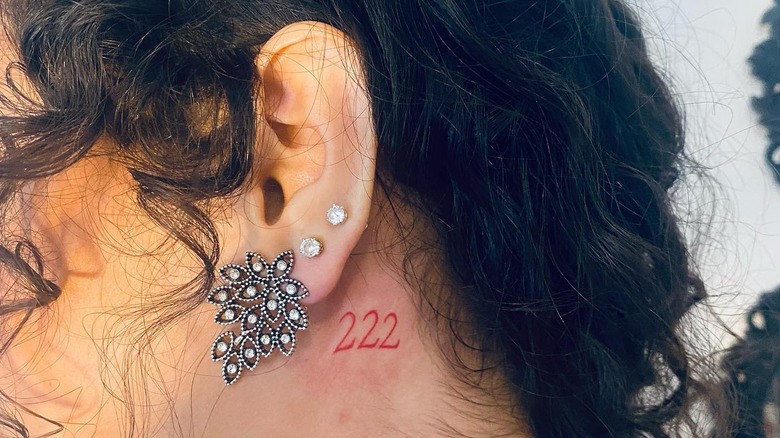 222 tattooed behind ear