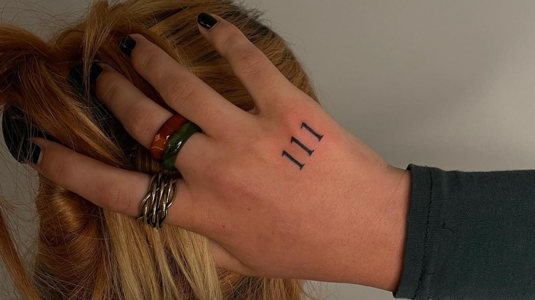 111 tattooed on the hand