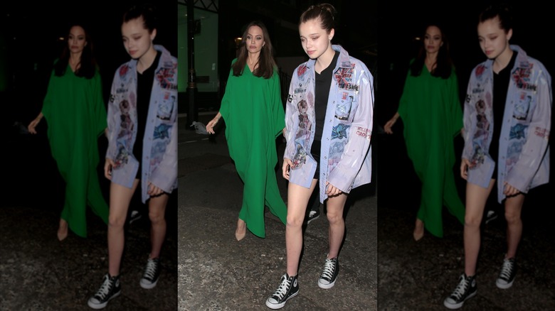 Angelina Jolie and Shiloh Jolie walking outside at night, Shiloh in jean jacket.