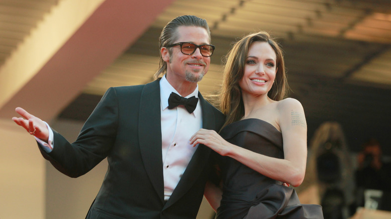 Angelina Jolie posing on the red carpet with Brad Pitt