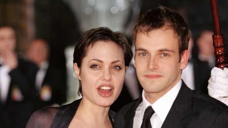 Angelina Jolie posing with Jonny Lee Miller