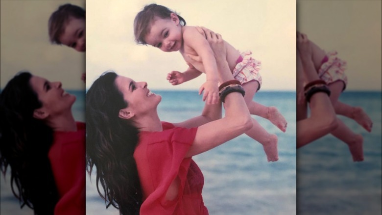 Angie Harmon holding young Finley Faith