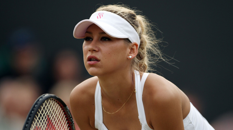 Anna Kournikova in her tennis gear holding racket