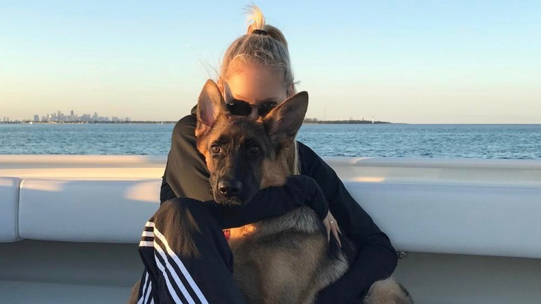 Anna Kournikova cuddling her dog on her boat