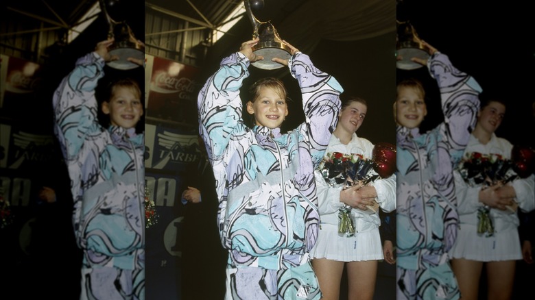 Young Anna Kournikova holds a trophy