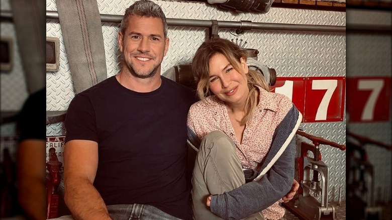 Ant Anstead and Renée Zellweger sit on a fire engine