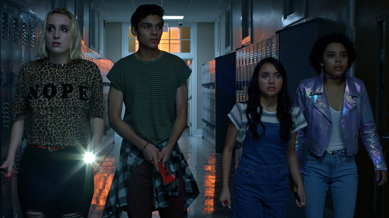 The cast of Student Body walking through a dark hall