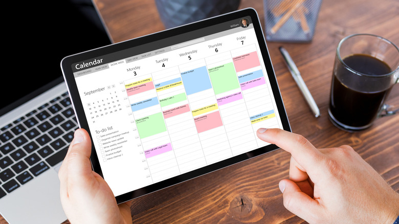 Person using tablet with calendar app