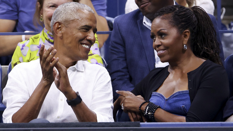 Barack and Michelle Obama smiling at each other