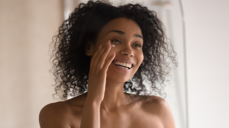 Woman applying eye cream