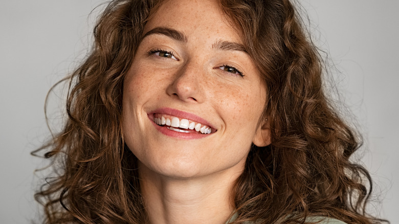 Woman with freckles smiling