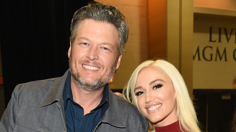 Blake Shelton and Gwen Stefani smile for the camera. 