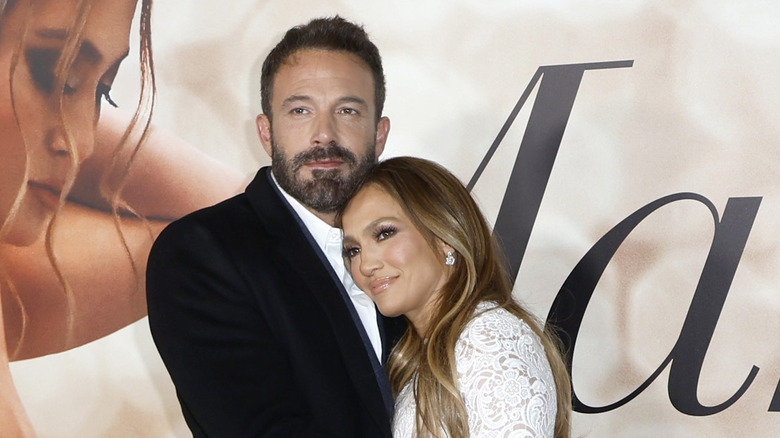 Ben Affleck and Jennifer Lopez embrace at an event. 