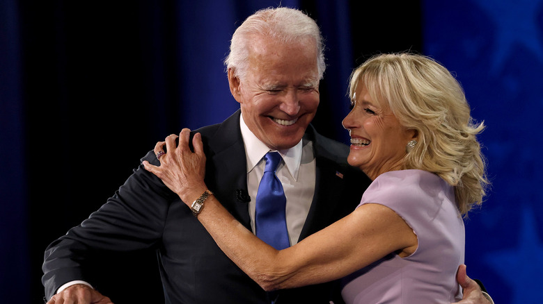 Joe and Jill Biden embrace at an event. 