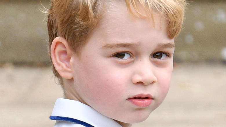 Prince George poses for the camera.