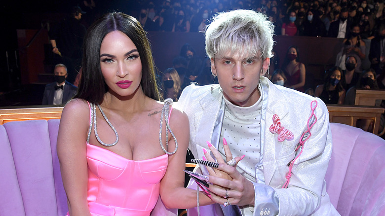 Machine Gun Kelly and Megan Fox pose for a photo. 