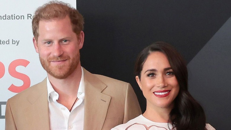 Prince Harry and Meghan Markle pose for a photo. 