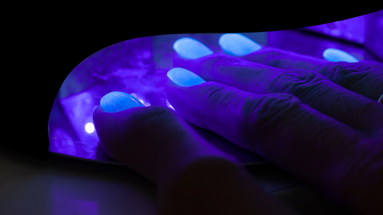 A close up of UV light drying gel nails 