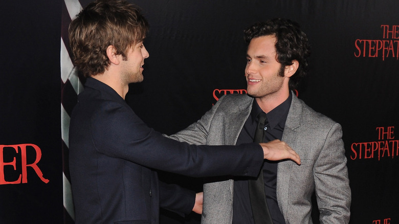 Penn Badgley and Chace Crawford go in for a hug at an event 