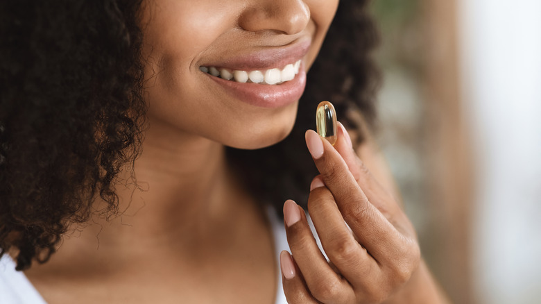 Woman taking personalized vitamins