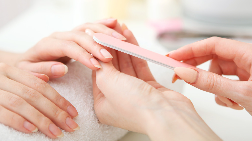 Woman getting manicure