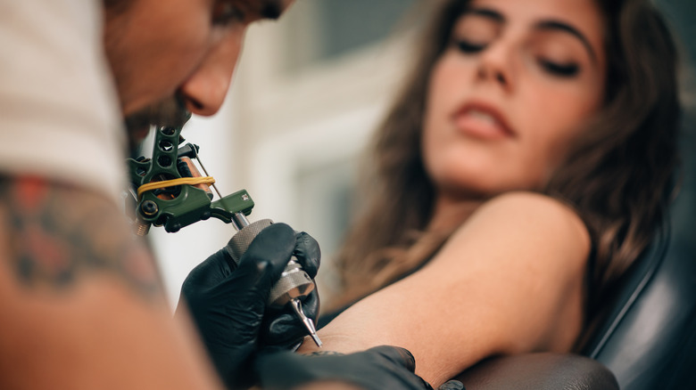 Woman getting a tattoo