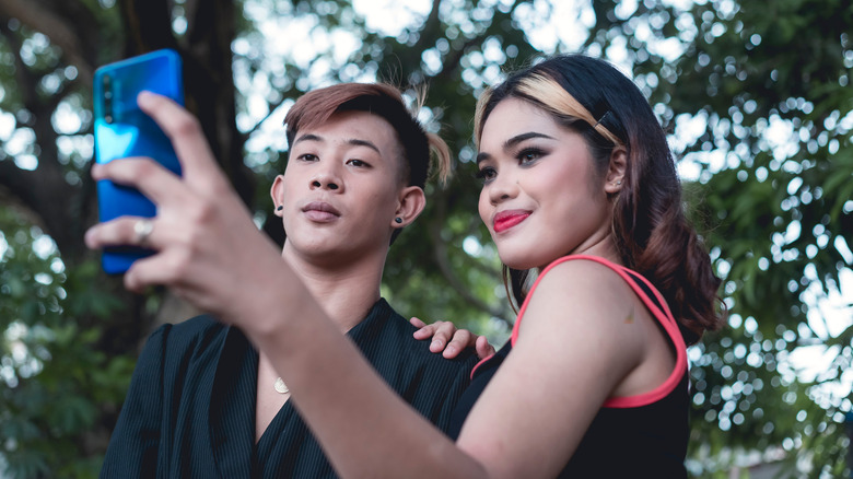 Woman taking selfie with boyfriend