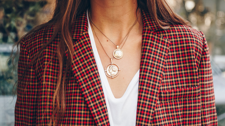 Woman wearing layered necklaces