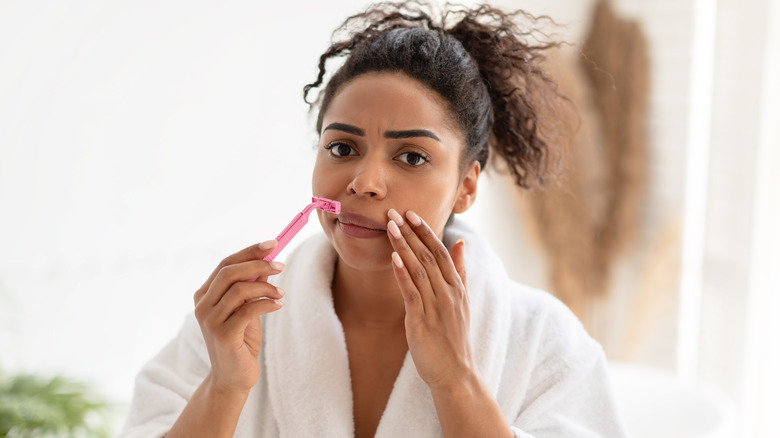 woman shaving face