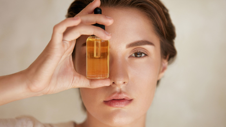 Woman holding face oil