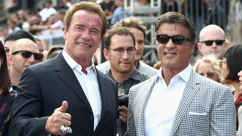 Arnold Schwarzenegger and Sylvester Stallone posing