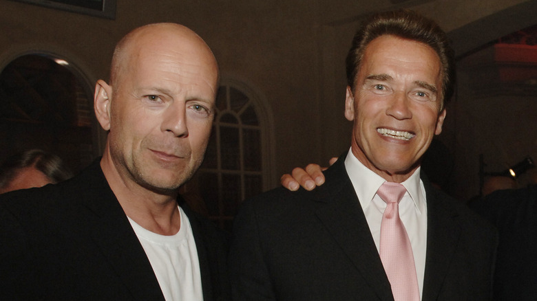 Arnold Schwarzenegger and Bruce Willis smiling together