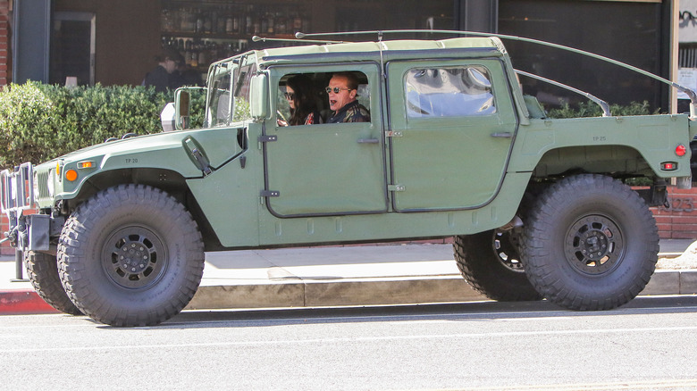 Arnold Schwarzenegger driving a Hummer