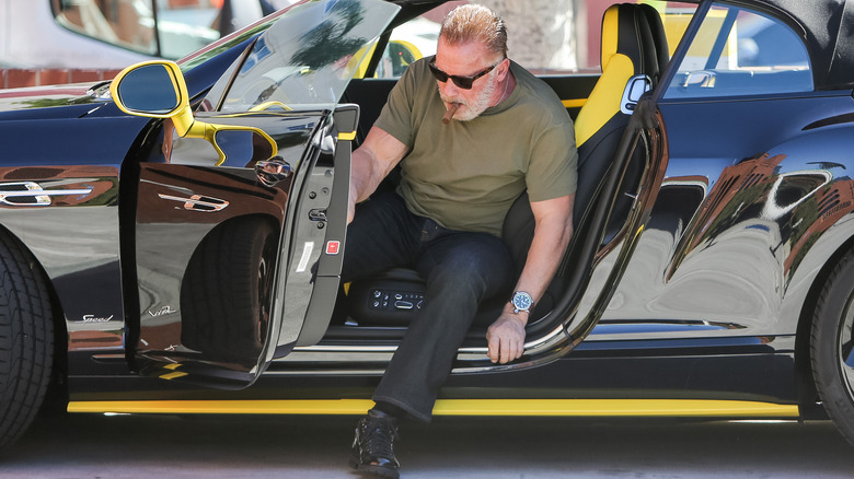 Arnold Schwarzenegger getting out of his car