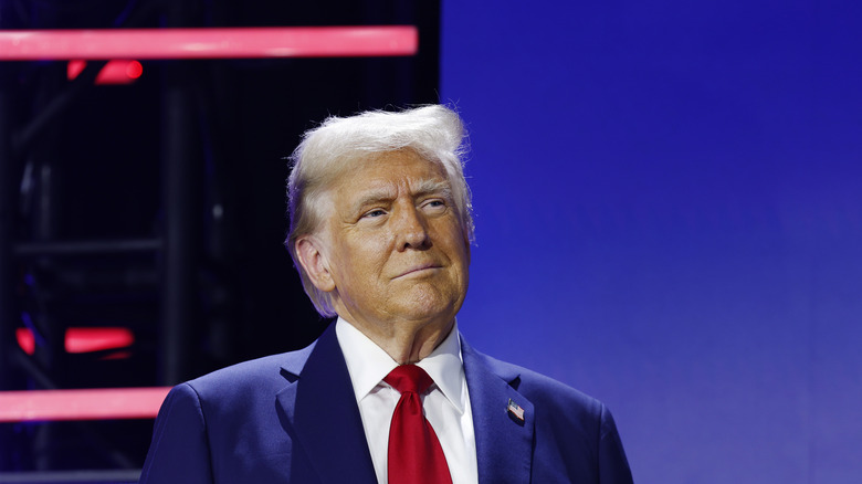 Donald Trump slightly smiling in a blue suit