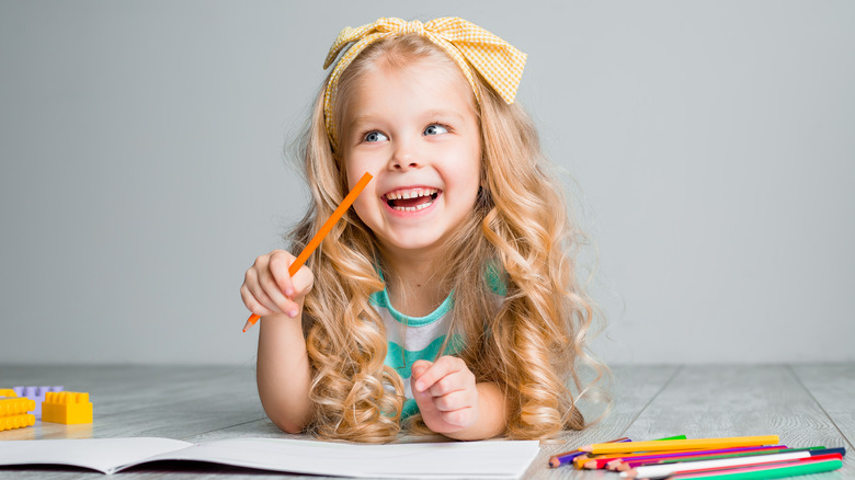 Girl and colored pencils