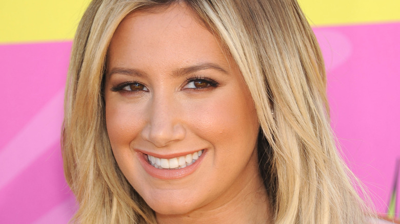 Ashley Tisdale smiling on the red carpet