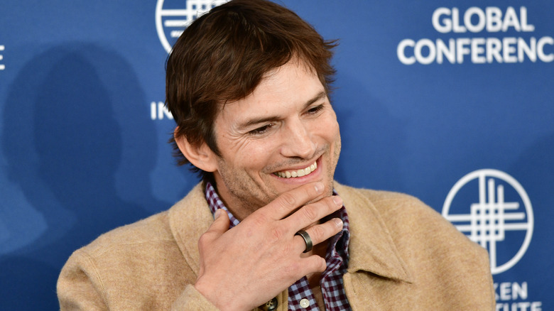 Ashton Kutcher laughing at concerence