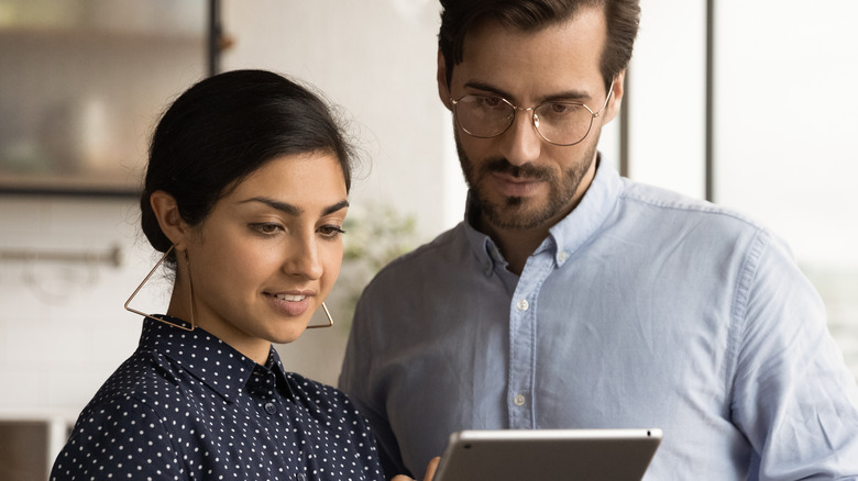 Man and woman looking at iPad 