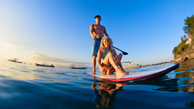A man and woman paddleboarding in Australia 