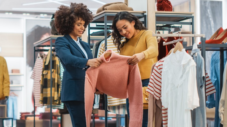 Two women shopping for clothes. 