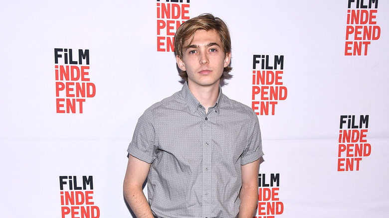 Austin Abrams posing at Puzzle event 