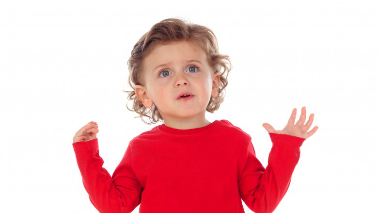 curious toddler in a red shirt