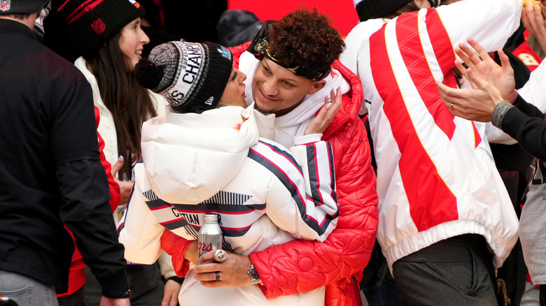 Patrick Mahomes grabbing Brittany Mahomes for a dance at the parade