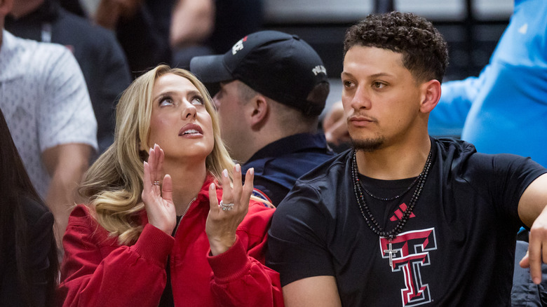 Brittany Mahomes clapping and looking up while Patrick looks to his right