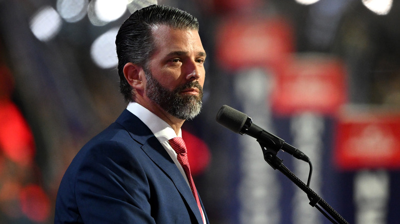 Donald Trump Jr. standing at a microphone