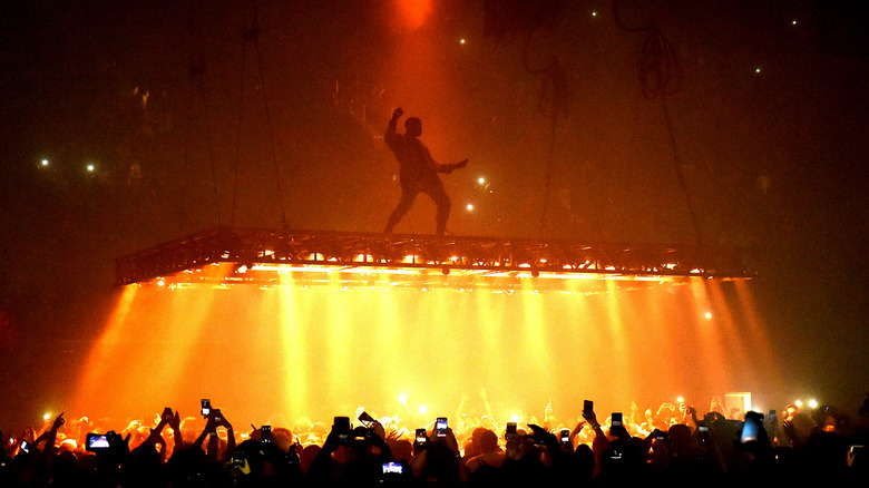 Kanye West performing orange lights